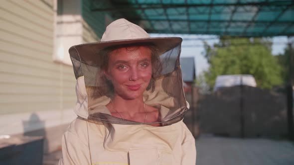 Portrait of a Young Girl Who Extracts Honey on a Bee Apiary