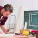 A Bearded Handyman Analyzes the Design on a Piece of Paper and Smartphone The Carpenter Arranges the - VideoHive Item for Sale
