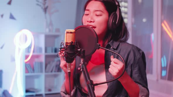 Asian Female Singer Recording Song with Afro-American Friend at Home Studio alt