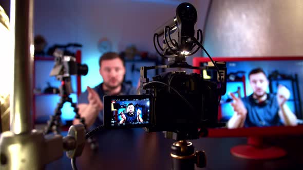 Blogger is Broadcasting in Video Studio with Cameras and Professional Lighting