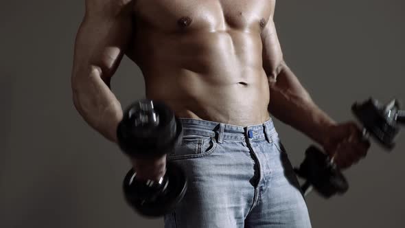 Handsome Power Athletic Man with Dumbbell. Strong Bodybuilder with Six Pack, Perfect Abs, Shoulders alt
