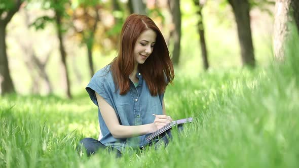 beautiful young woman with note in park