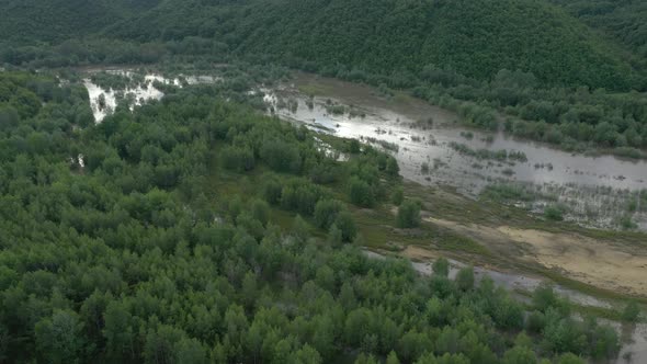 Flying above river floods after heavy rain 4K aerial video alt