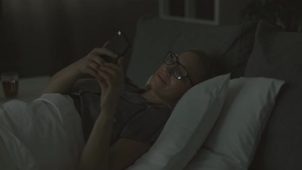 Woman Using Mobile Before Sleep