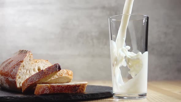 Fresh Bread and Milk Whose Poured Into a Glass