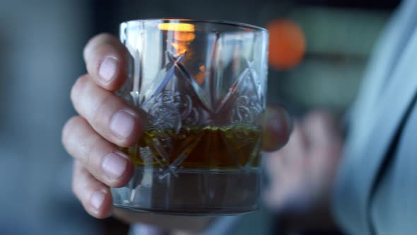 Businessman Hands Drinking Whiskey in Office Closeup alt
