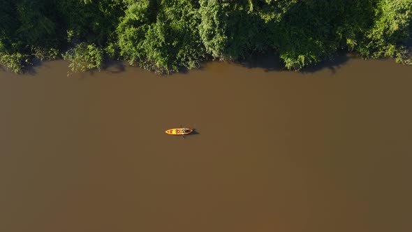 Kayaker Rowing Along Tropical River in Pantanal Brazil