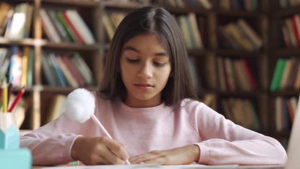 Happy Indian School Girl Learning Online Class Watching Video Lesson on Laptop alt