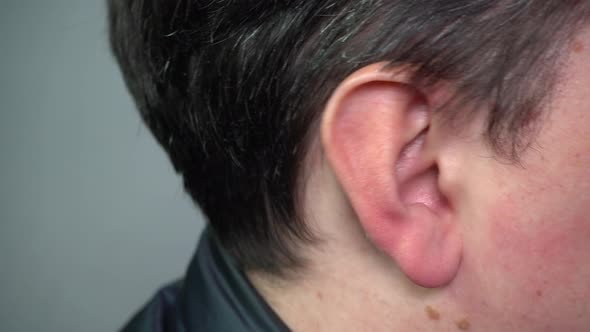 The Ear of a Young Man in Closeup alt