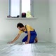 A Professional Master of Underfloor Heating Installation is Laying Out and Glue the Insulation for - VideoHive Item for Sale