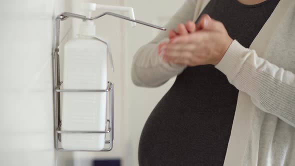 Close Up Young Pregnant Woman Treats Disinfects Hands With Antiseptic Before Medical Control On alt