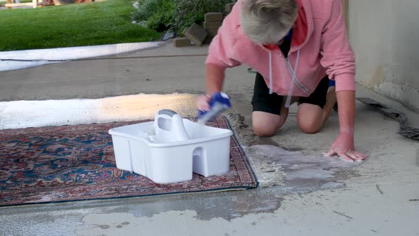 Hand cleaning an oriental or Persian carpet with soap and water - medium, panning shot alt