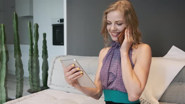 Young Woman With Working On Tablet And Speaks By Phone.