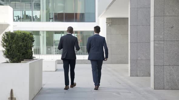 Diverse Businessmen Walking Outdoors alt