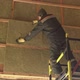 Man laying insulation at height - VideoHive Item for Sale