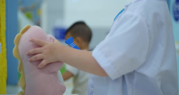 Cute Preschool Boy Kid Wearing White Medical Uniformlistening to Pets Breathingparrots and Toy alt