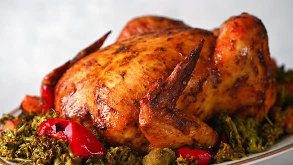Delicious whole chicken cooked with pumpkin, pepper and broccoli. Baked chicken with vegetables
