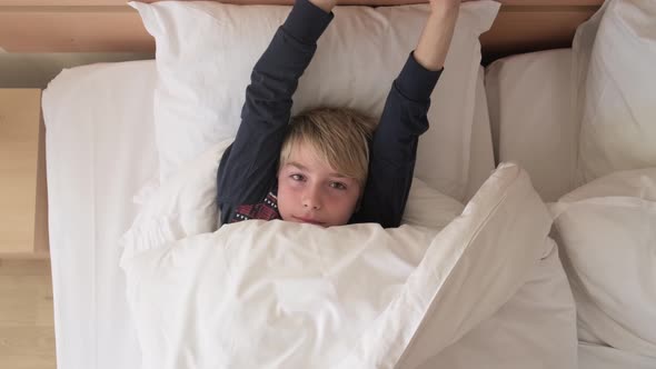 Funny kid under blanket at the morning. alt