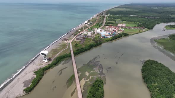 Anaklia, Georgia - July 16 2022: Aerial view of Anaklia-Ganmuhkuri Pedestrian Bridge at sunset alt
