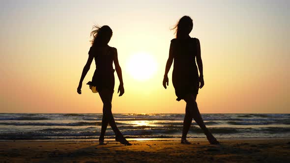 Silhouette of Sporty Young Women Practicing Dancing Element on the Beach.
