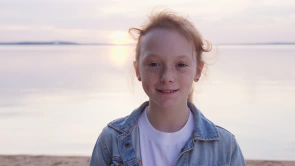 Redheaded Girl with Freckles By Sea at Sunset