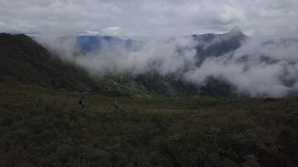 Aerial - Couple of hikers walking on a atlantic forest mountain in Rio de Janeiro, Brazil alt