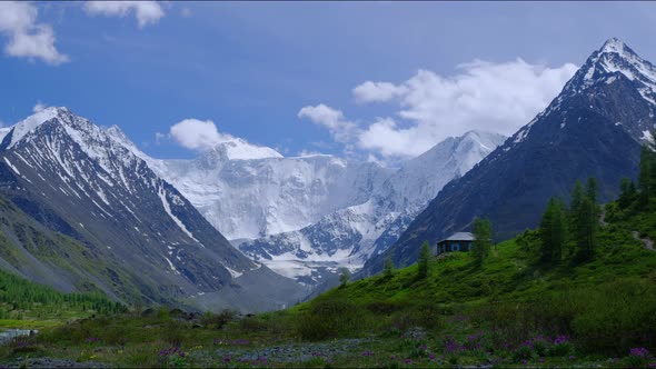 Timelapse of the Two Peaks of the Russian Mountain Belukha in the Clouds Floating in the Sky