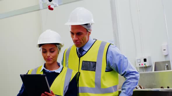 Workers using digital tablet alt