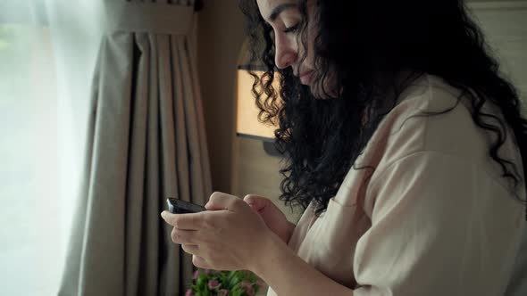 Close Up Portrait Young Caucasian Woman Using Smartphone While Sitting on Sofa alt