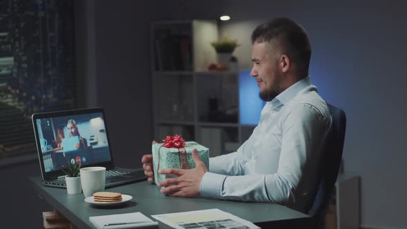 Multiracial Man and Woman Making Online Video Meeting to Open the Received Presents From Each Other
