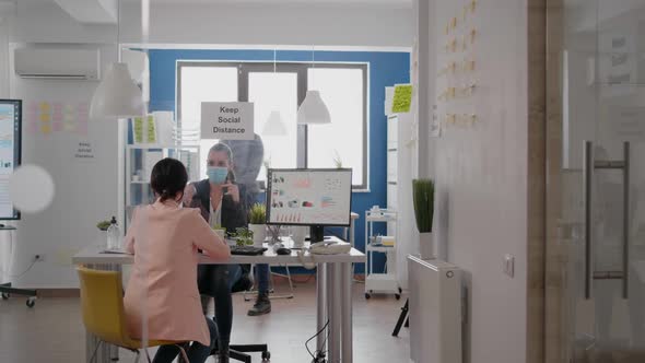 Coworkers Working at Business Meeting Wearing Protective Face Mask alt