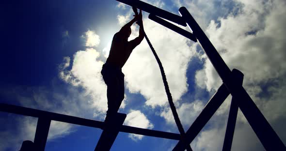 Military soldier climbing rope during obstacle course 4k alt