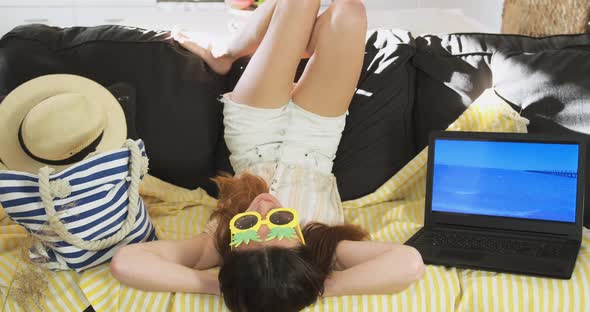 Funny Woman Dreams of Beach Holiday at Home Near Laptop with Seascape alt