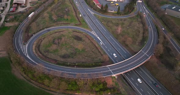Aerial View of Highway Road Intersection with Fast Moving Heavy Traffic alt