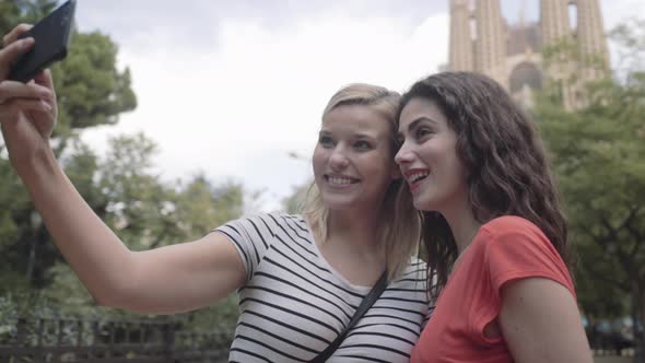 Young adult women taking picture of Cathedral, Barcelona