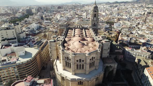 Drone tilt-up reveals majestic architecture of Malaga Cathedral, city views