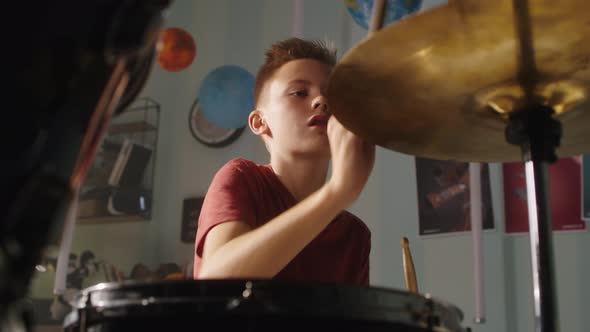 Teenager Playing Drums at Home alt