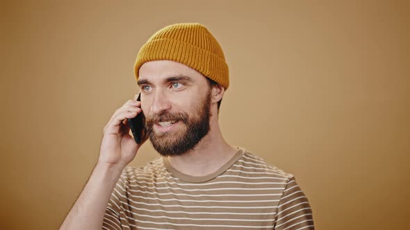 Middleaged Hipster Talks on Smartphone in Studio Closeup alt