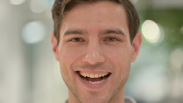 Close Up of Face of Creative Young Man Smiling at the Camera alt
