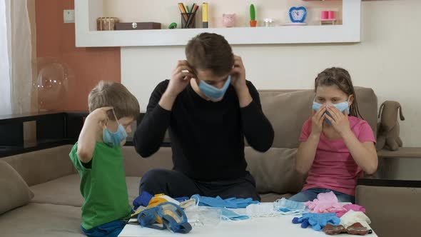 The Older Brother Teaches the Children To Wear a Medical Mask and Rubber Gloves . Social Distancing
