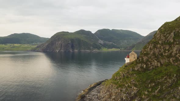 Hendanes Lighthouse On Rugged Mountain Slope At The North Sea Coast In Maloy Region, Norway. aerial alt