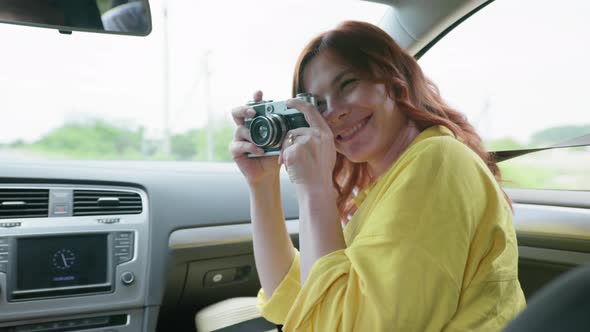 Travel, Joyful Attractive Woman Having Fun and Taking Pictures with Retro Camera While Traveling By alt