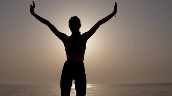 Stunning Backside View of a Slender Fit Girl Standing Against the Sea alt