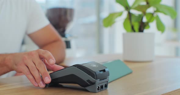 Close Up in the Cafe Man Makes Coffee for a Customer Who Pays By Contactless Mobile Phone to Credit alt