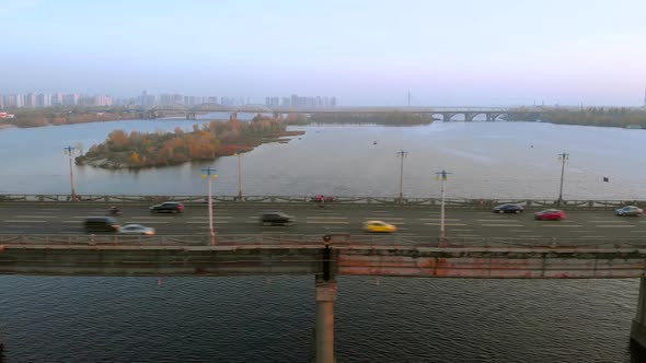 Cars Ride Across the River on a Road Bridge