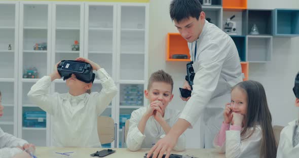 Little Children Teens in the Classroom Watching in Virtual Reality Glasses alt