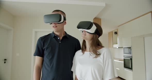 Man and Woman Wearing VR Headsets in New House