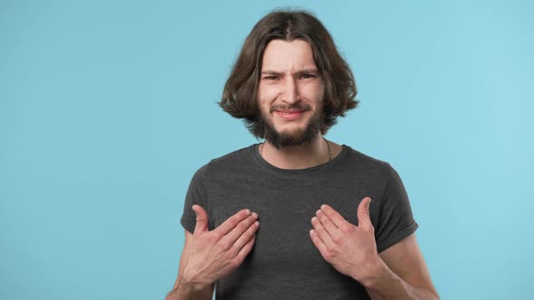 Portrait of Aggressive Impolite Man 20s with Beard Wearing Casual Gray Tshirt Ready for Fight and alt