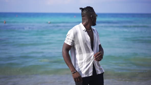 Medium Shot Portrait of African American Young Man Stretching Neck with Turquoise Blue Mediterranean alt