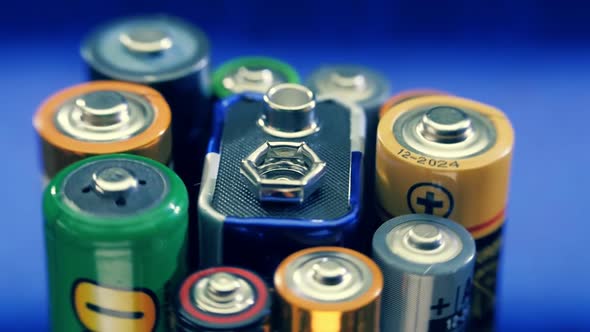 Alkaline Batteries Rotates On The Blue Background